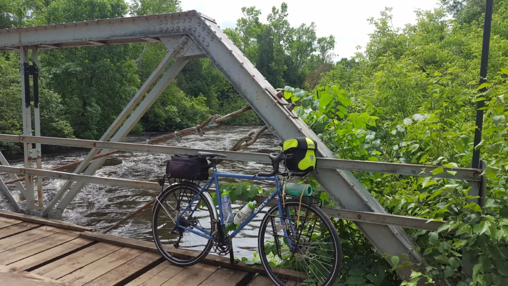 Water looks high spring riding at the old bridge outside of Pentoga Village. New bridge is being planned. This one has survived many floods where all others older bridges here were lost.