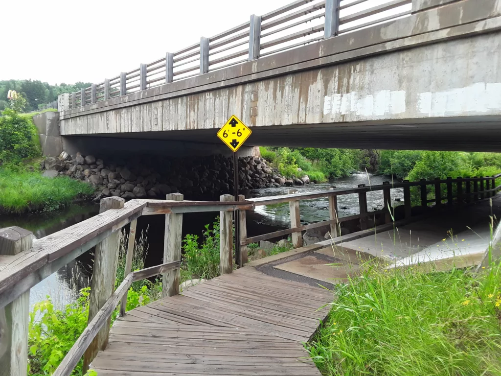 Located under the US 2 bridge in Iron River is a wooden boardwalk, start of the Apple Blossom Trail leading to Caspian then Gaastra.