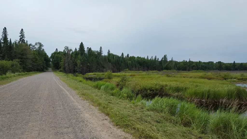 When exploring U.P. Michigan often the road turns to gravel. Can be soft and rough riding for road bikes. This section was Smokey Lake Road west of Iron River. Pavement ended and about 5 miles of gravel on the Michigan side.