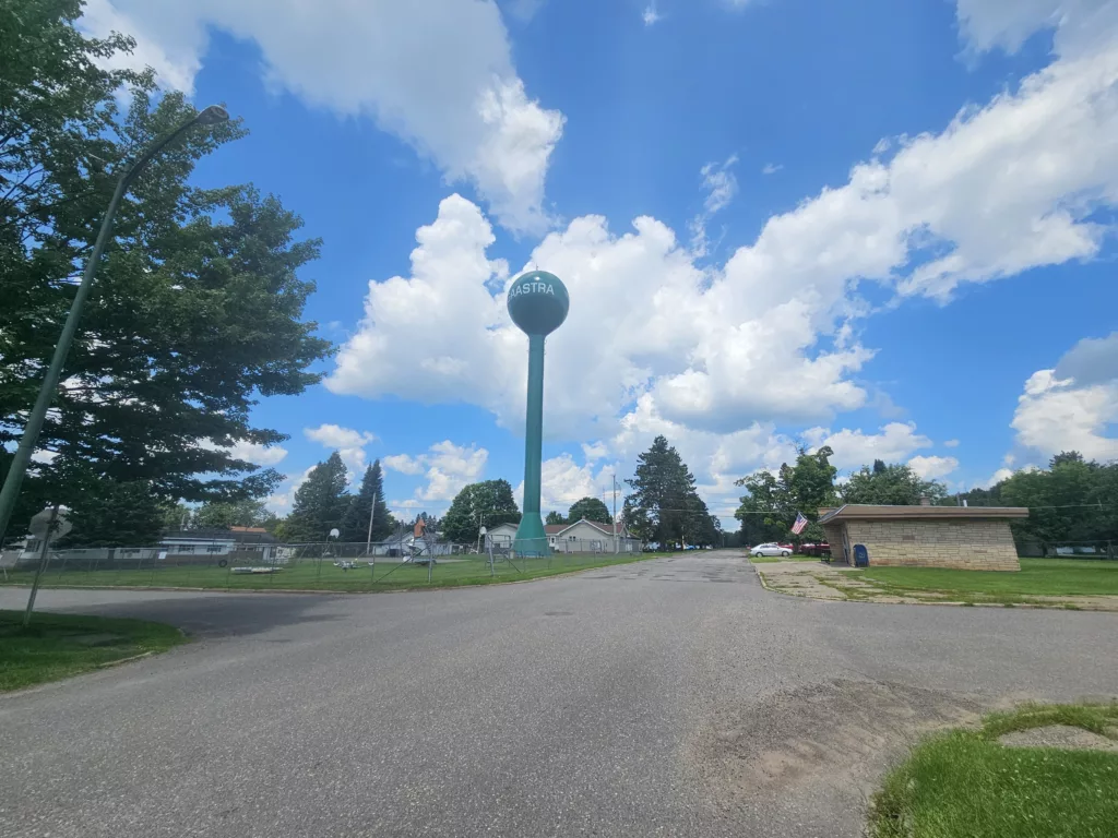 New paint on the Gaastra Water tower on 2nd Street. View of the old playground with vintage rides, and the post office in Gaastra Michigan.